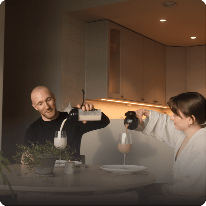 A30 year old man and woman drinking MËTTA food shake. 
