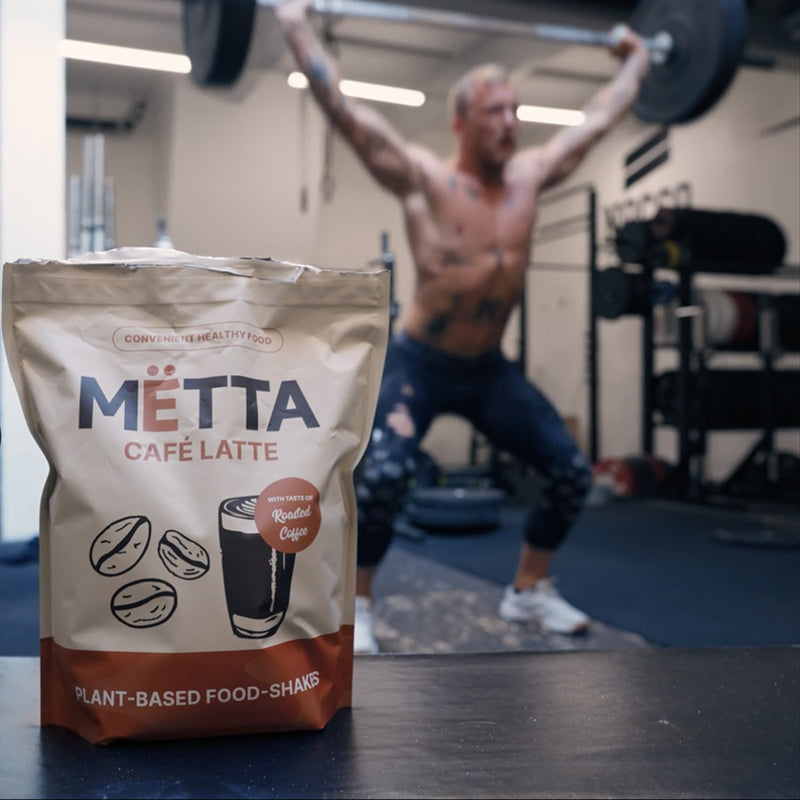 Lifting weights and featuring METTA caffe latte food shake large bag.