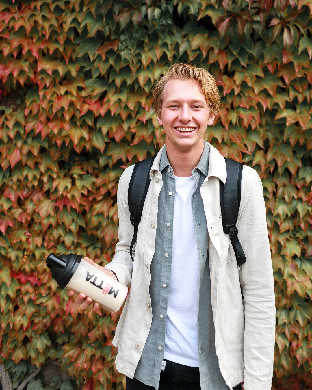 a 18 year old student holding a prepared MËTTA food shake.